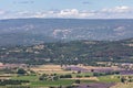 Panoramic view Luberon hills covered with lavender fields, vineyards, apple orchards, forests from top of historic hill villageÃÂ  Royalty Free Stock Photo